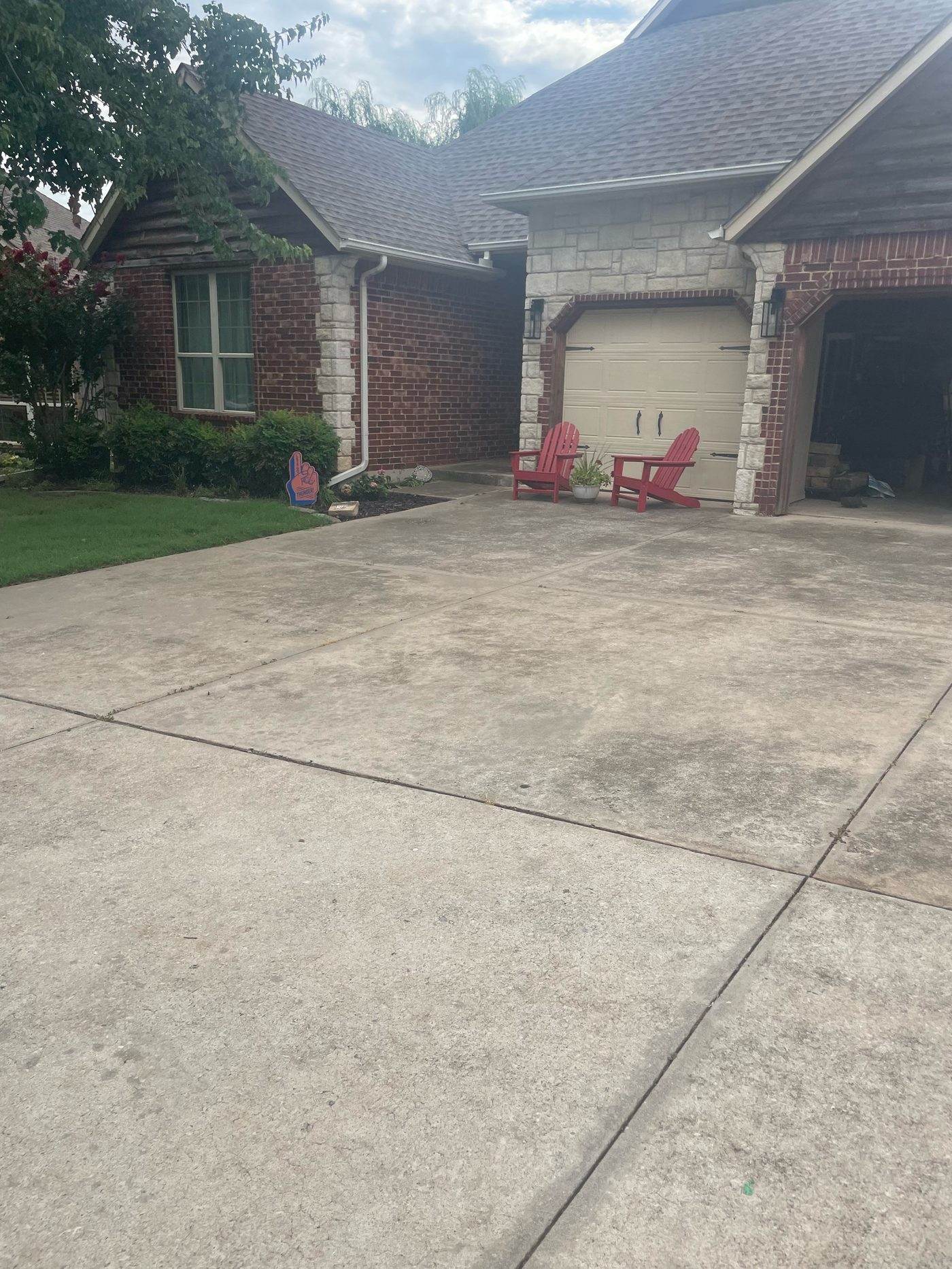 Driveway before cleaning, stained with tire marks and dirt