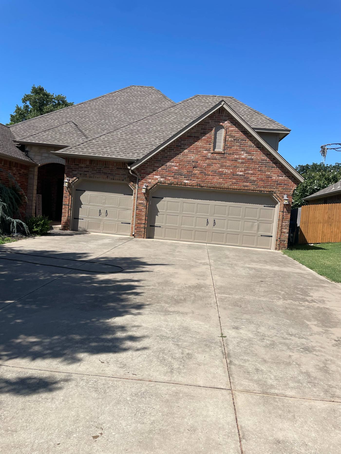 Large driveway before cleaning, grimy and stained concrete